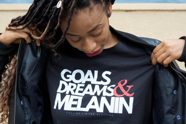 Woman looks at her own shirt with a powerful slogan